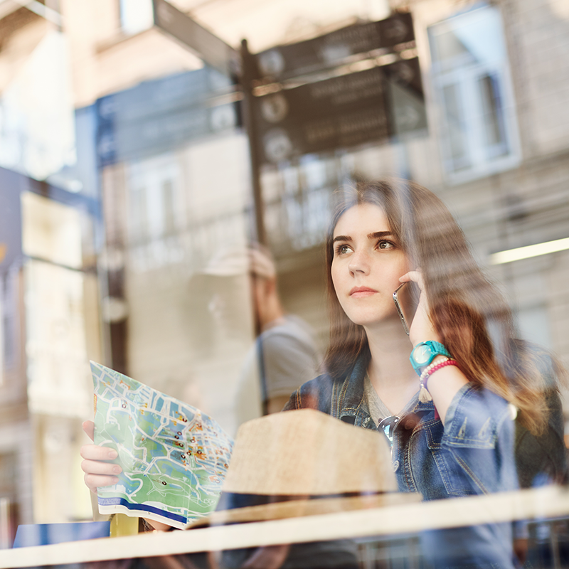 Traveller checking directions discreetly