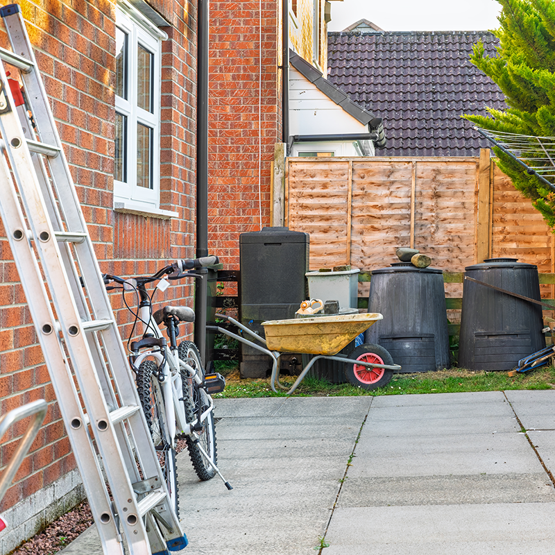Garden items and ladder outside a home